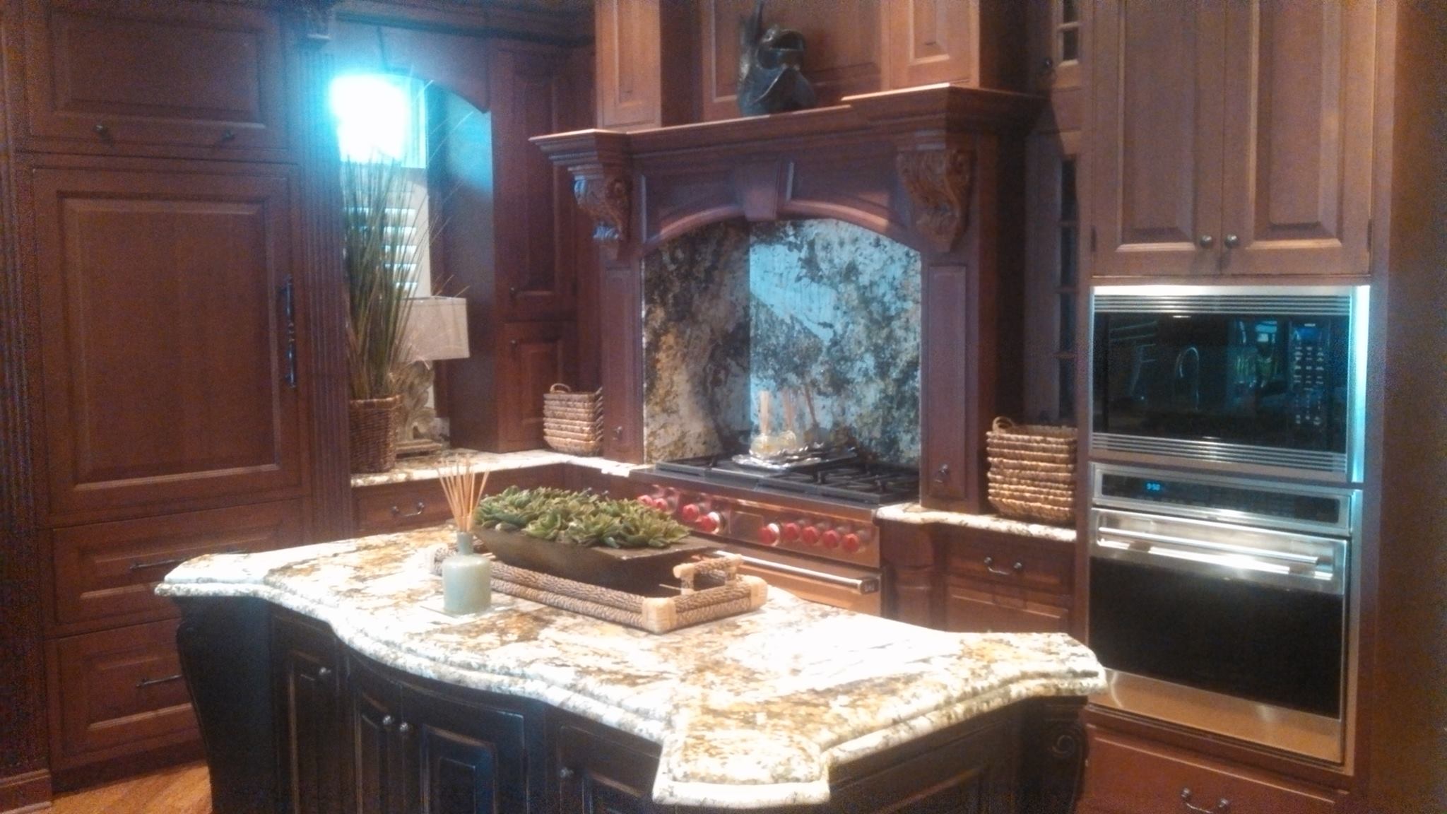 A finished kitchen with built-in oven, microwave and range